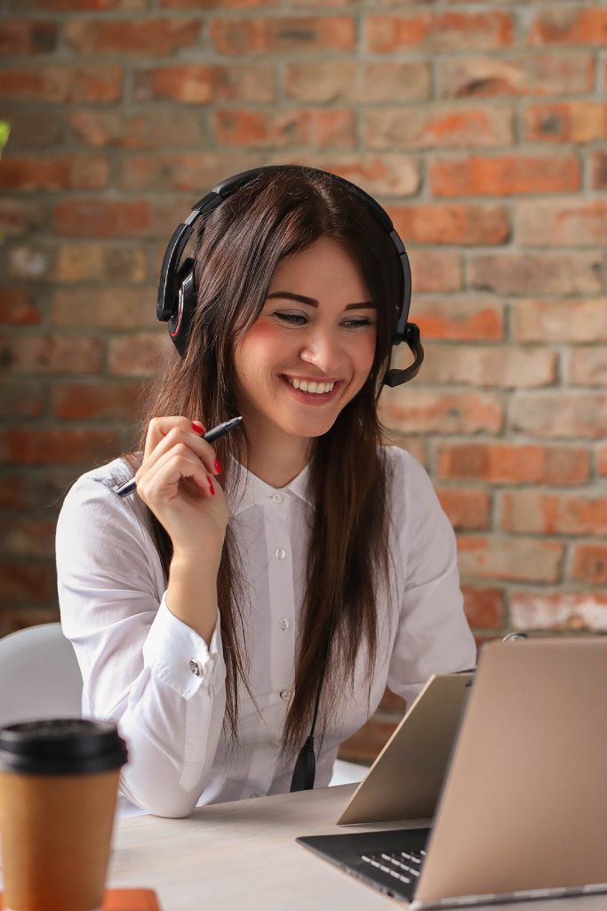 smiling girl uses laptop