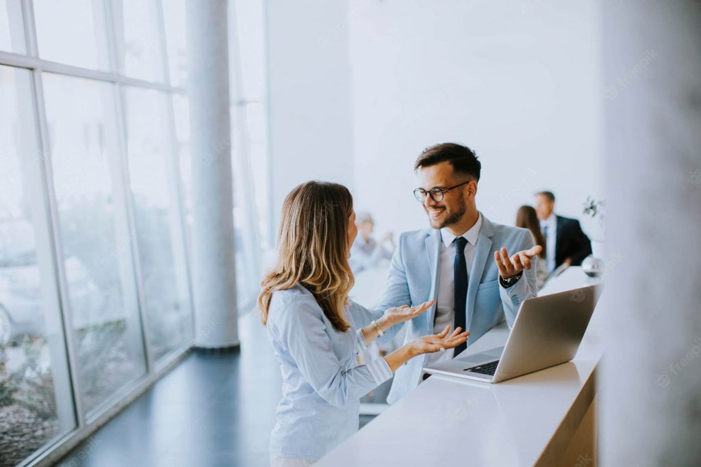 Young Business Couple Working Discussing By Laptop Office Front Their Team